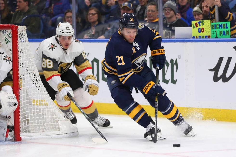 Buffalo Sabres forward Kyle Okposo (21) carries the puck past Vegas Golden Knights defenseman N ...