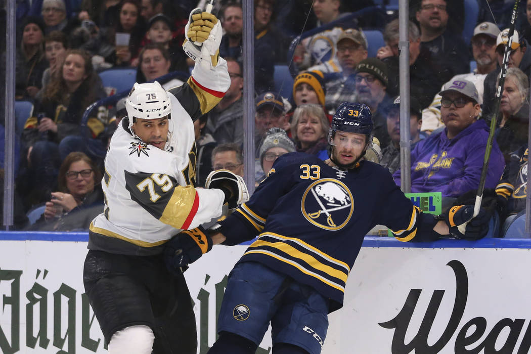 Buffalo Sabres defenseman Colin Miller (33) and Vegas Golden Knights forward Ryan Reaves (75) c ...