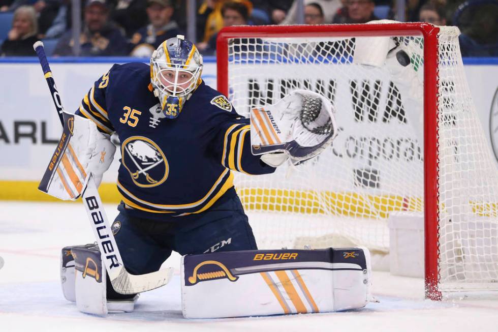 The puck hits the post behind Buffalo Sabres goalie Linus Ullmark (35) during the second period ...