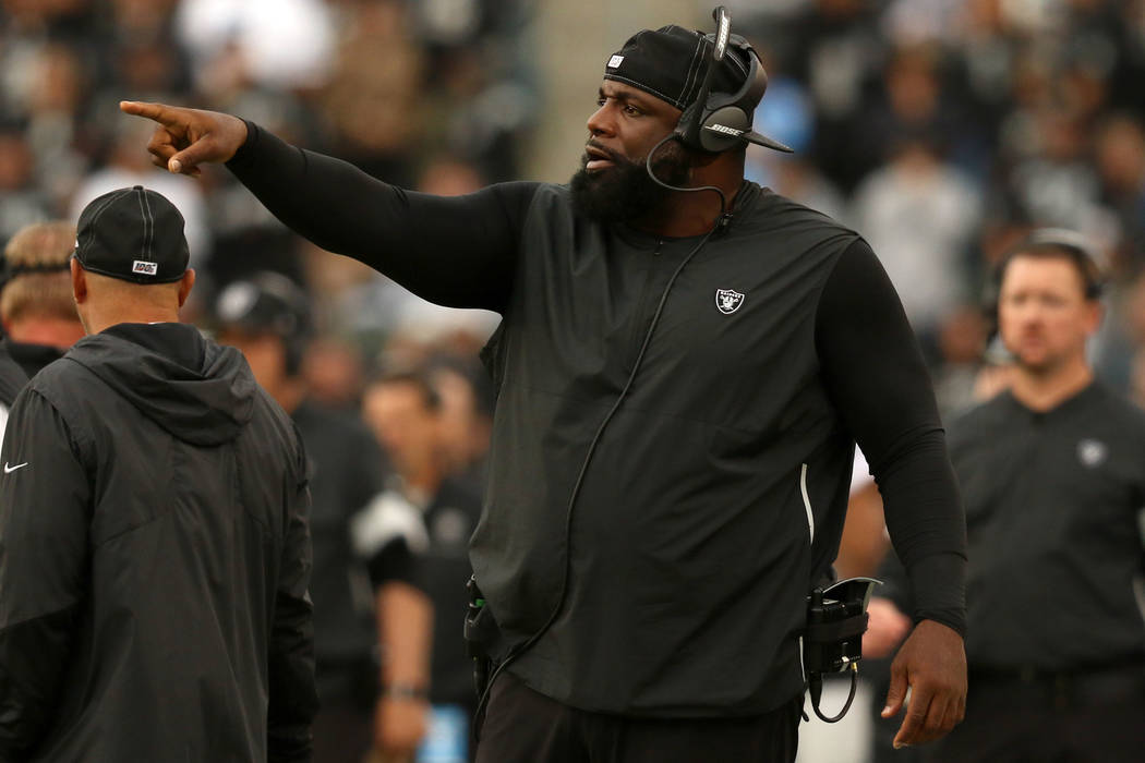 Oakland Raiders defensive line coach Brentson Buckner gestures to his players from the sideline ...