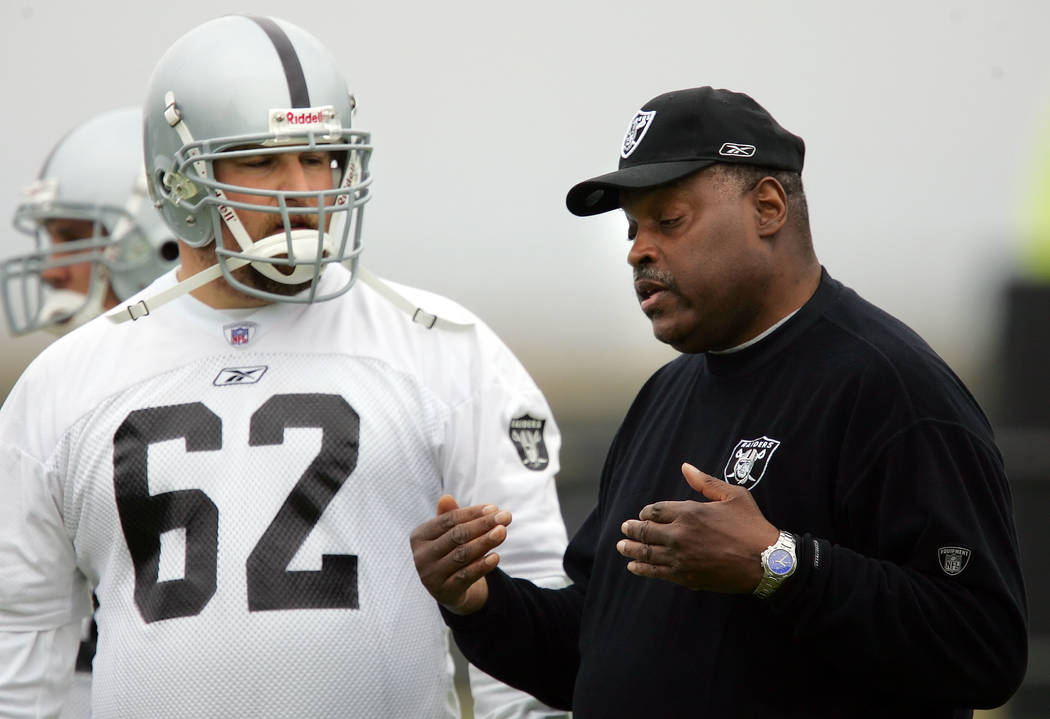 Oakland Raiders coach Art Shell, right, instructs offensive lineman Adam Treu (62) during footb ...