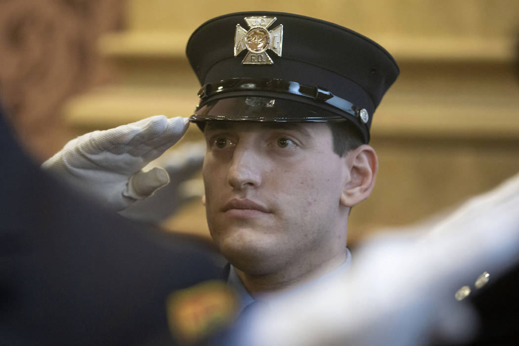 In this photo provided by the Jersey City, N.J. Mayor's Office, Sam Springsteen salutes during ...