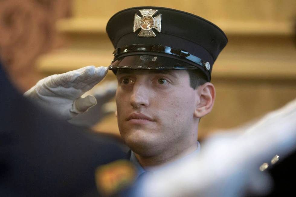 In this photo provided by the Jersey City, N.J. Mayor's Office, Sam Springsteen salutes during ...