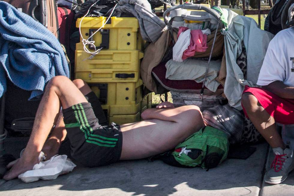In this May 3, 2018, file photo, a man sleeps on the ground on East Owens Avenue in Las Vegas. ...