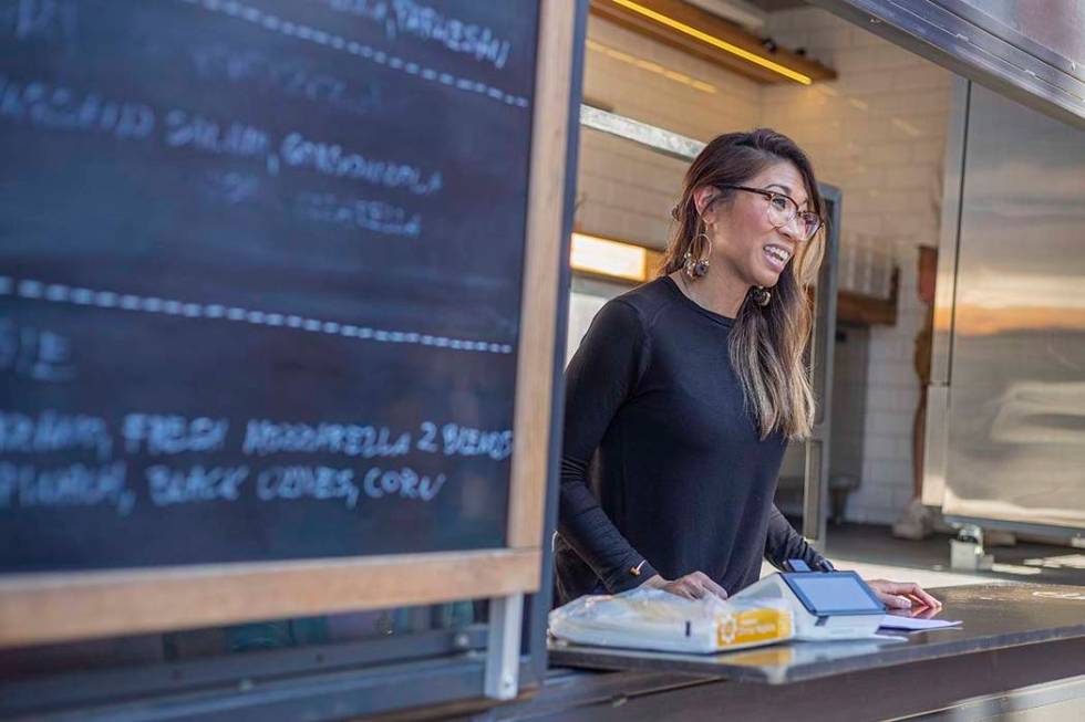 Rachelle Luna takes orders from the Custom Pizza Truck, parked on 317 S. Sixth St., in Las Vega ...