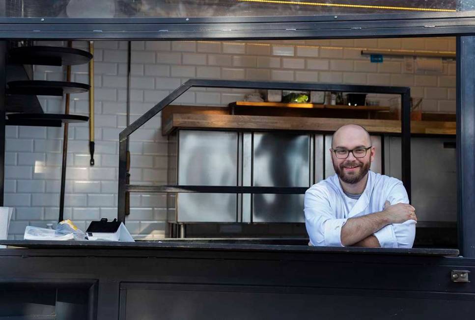 Chef Bartosz Wawrzyszak, owner of the Custom Pizza Truck, stands in his food truck parked on 31 ...