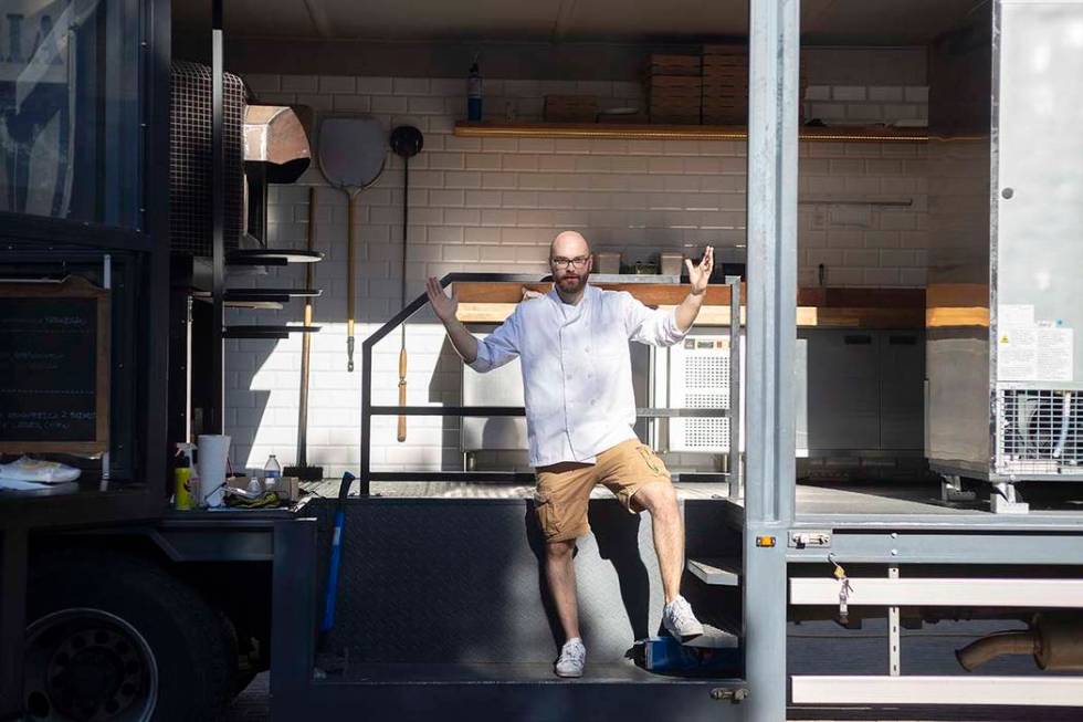 Chef Bartosz Wawrzyszak, owner of the Custom Pizza Truck, stands in his food truck parked on 31 ...