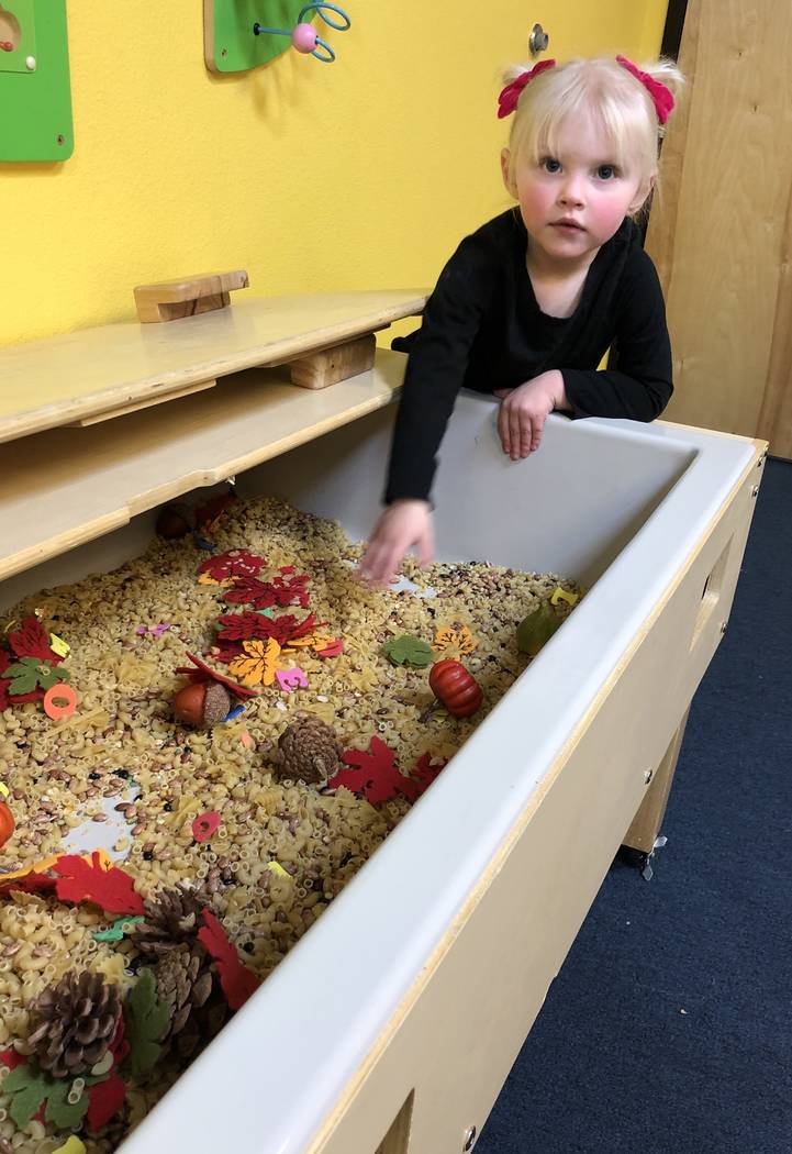 Emsley Kersenbrock, age 2 1/2, plays during a ribbon-cutting event Tuesday to announce the rebr ...