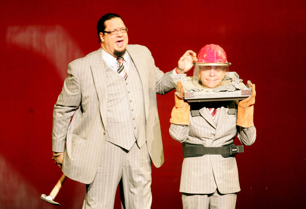 Comedic illusionists Penn Jillette, left, and Teller perform an illusion during their "Penn & T ...