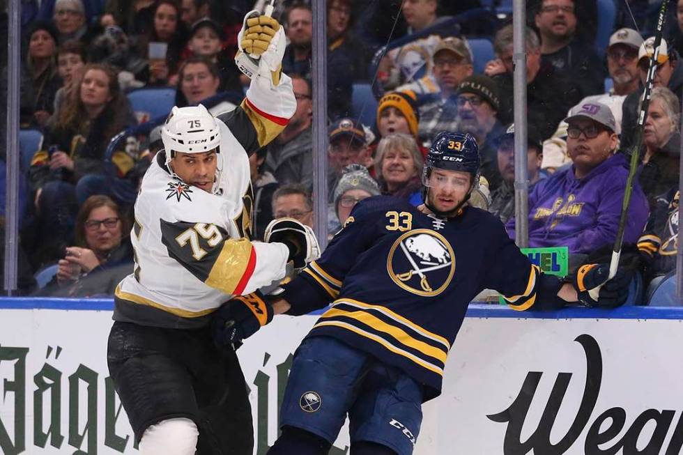 Buffalo Sabres defenseman Colin Miller (33) and Vegas Golden Knights forward Ryan Reaves (75) c ...