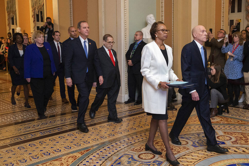 House Sergeant at Arms Paul Irving and Clerk of the House Cheryl Johnson carry the articles of ...