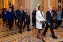 House Sergeant at Arms Paul Irving and Clerk of the House Cheryl Johnson carry the articles of ...