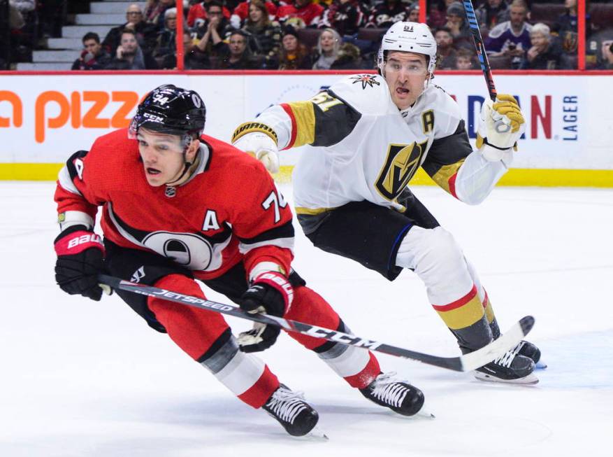 Vegas Golden Knights right wing Mark Stone (61) gives Ottawa Senators defenseman Mark Borowieck ...