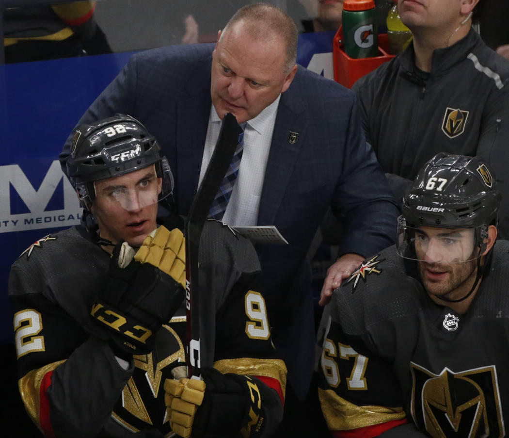 Vegas Golden Knights head coach Gerard Gallant, center, speaks to Vegas Golden Knights left win ...