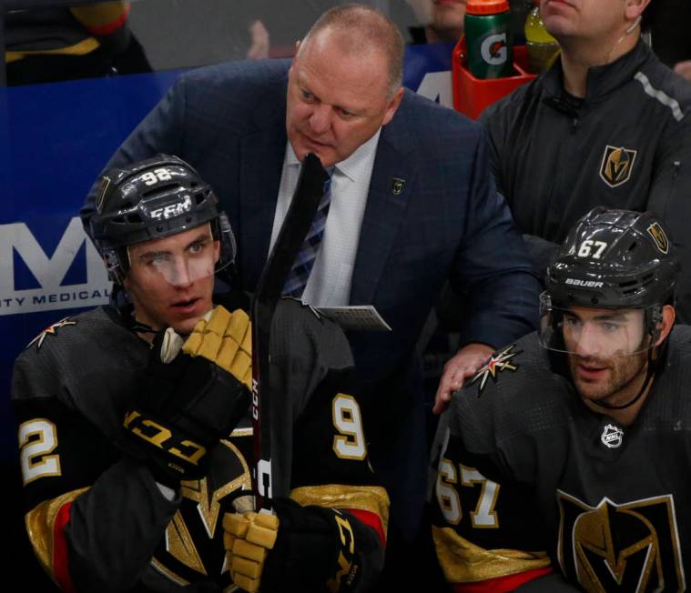 Vegas Golden Knights head coach Gerard Gallant, center, speaks to Vegas Golden Knights left win ...