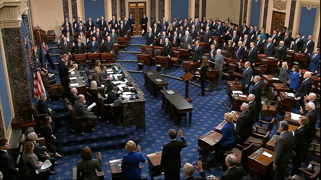 In this image from video, presiding officer Supreme Court Chief Justice John Roberts swears in ...