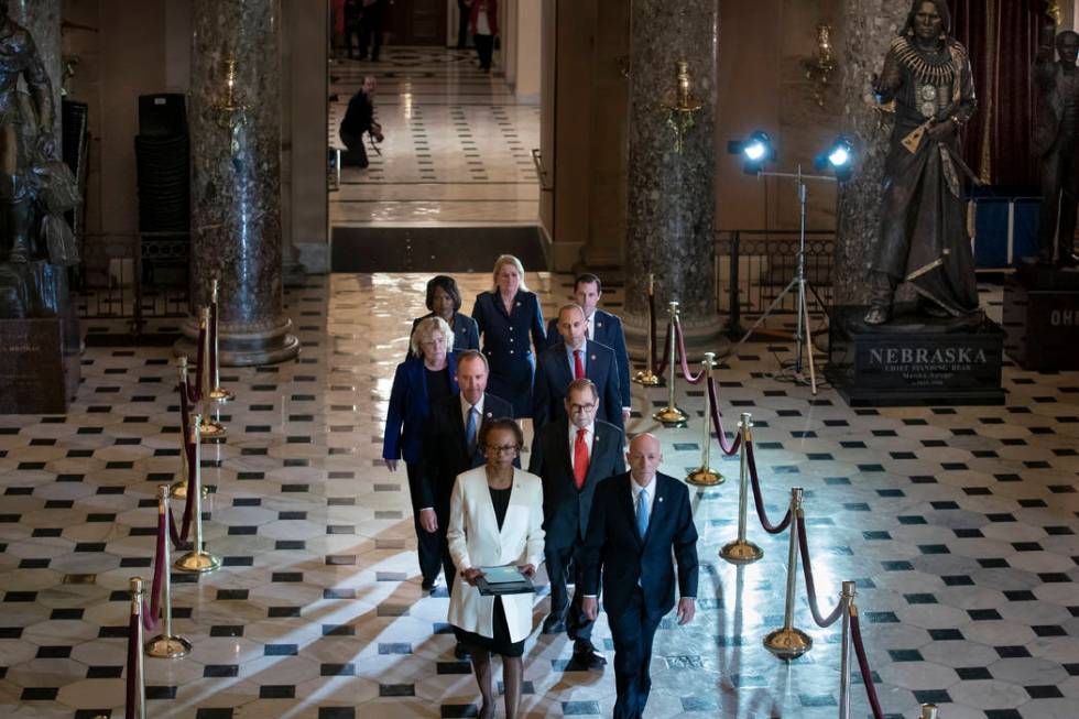 Clerk of the House Cheryl Johnson, left, and House Sergeant at Arms Paul Irving pass through St ...