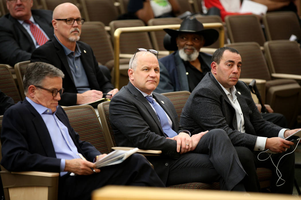 Raiders President Marc Badain, center, is flanked by Las Vegas Stadium Co. Chief Operating Offi ...