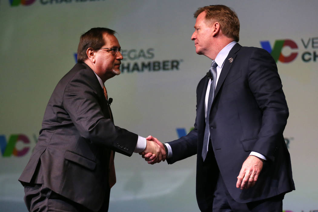 NFL Commissioner Roger Goodell, right, shakes hands with Las Vegas Review-Journal sports editor ...
