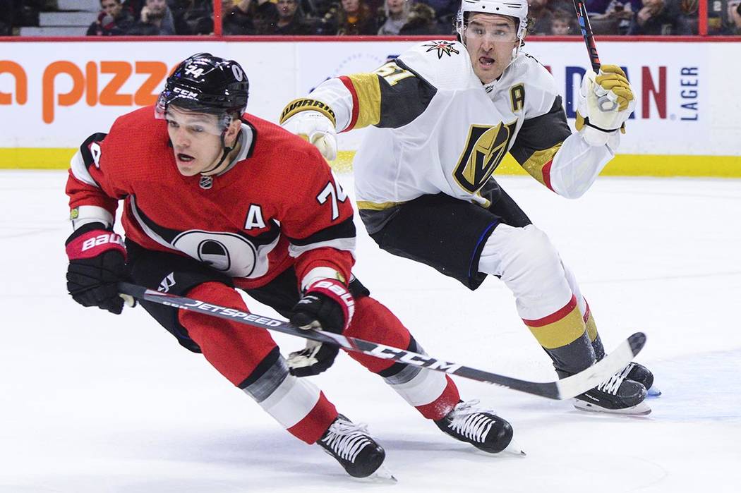 Vegas Golden Knights right wing Mark Stone (61) gives Ottawa Senators defenseman Mark Borowieck ...