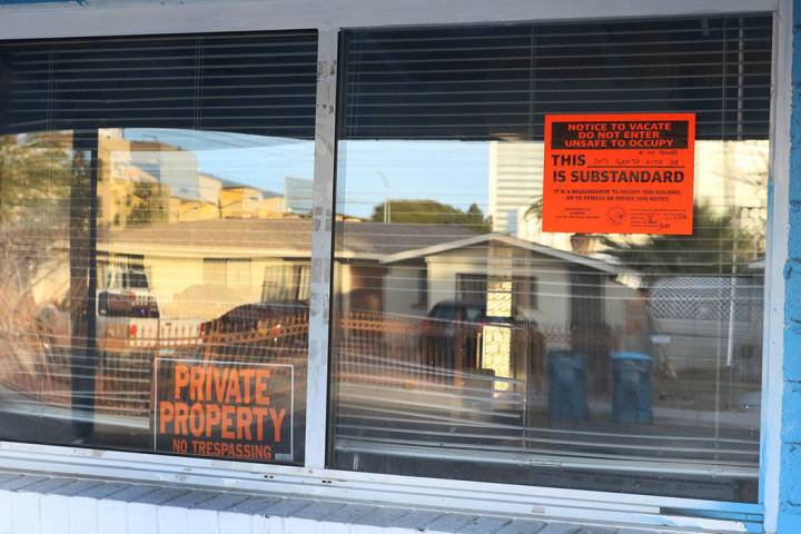 "Private Property" and "Unsafe to Occupy" signs are posted on the window of a house at 2017 S. ...