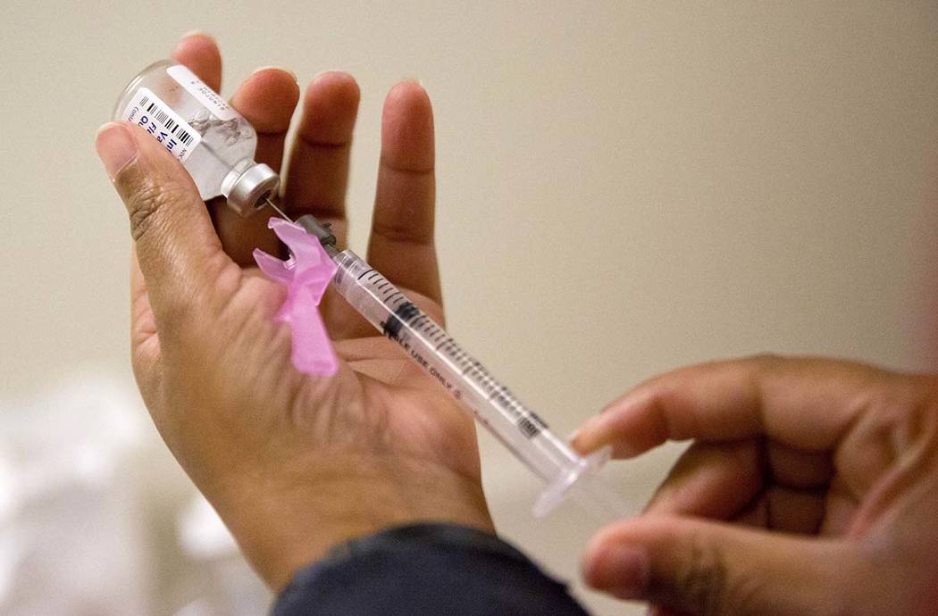 In a Feb. 7, 2018, file photo, a nurse prepares a flu shot at the Salvation Army in Atlanta. So ...