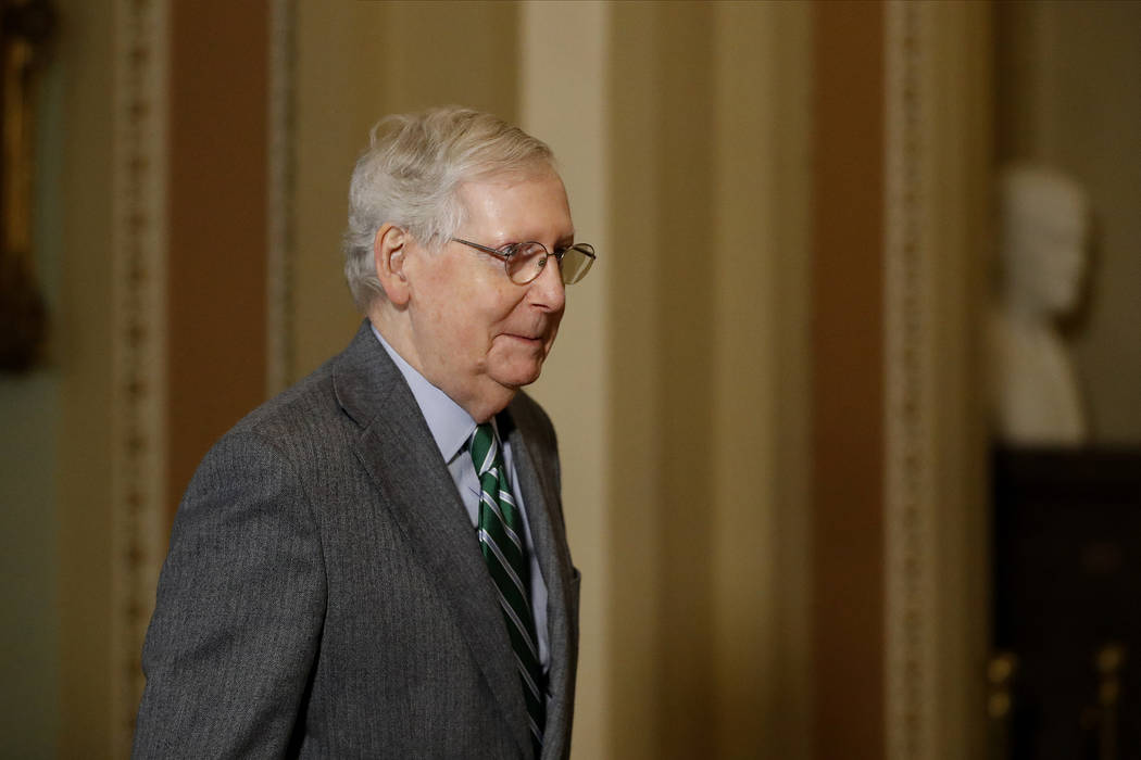 Senate Majority Leader Mitch McConnell, R-Ky., gestures while exiting the Senate chambers on Ca ...