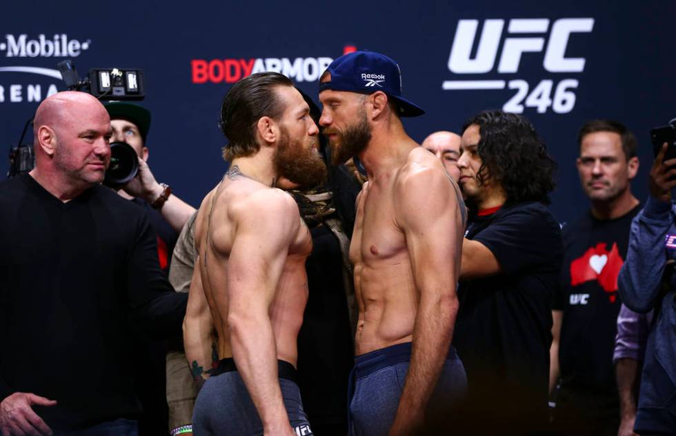 Conor McGregor, left, faces off against Donald "Cowboy" Cerrone ahead of their welter ...