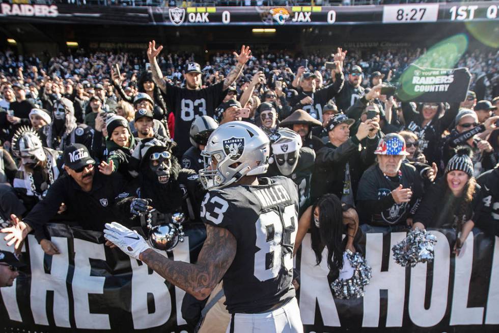 Oakland Raiders tight end Darren Waller (83) fires up the crowd in the "Black Hole" b ...