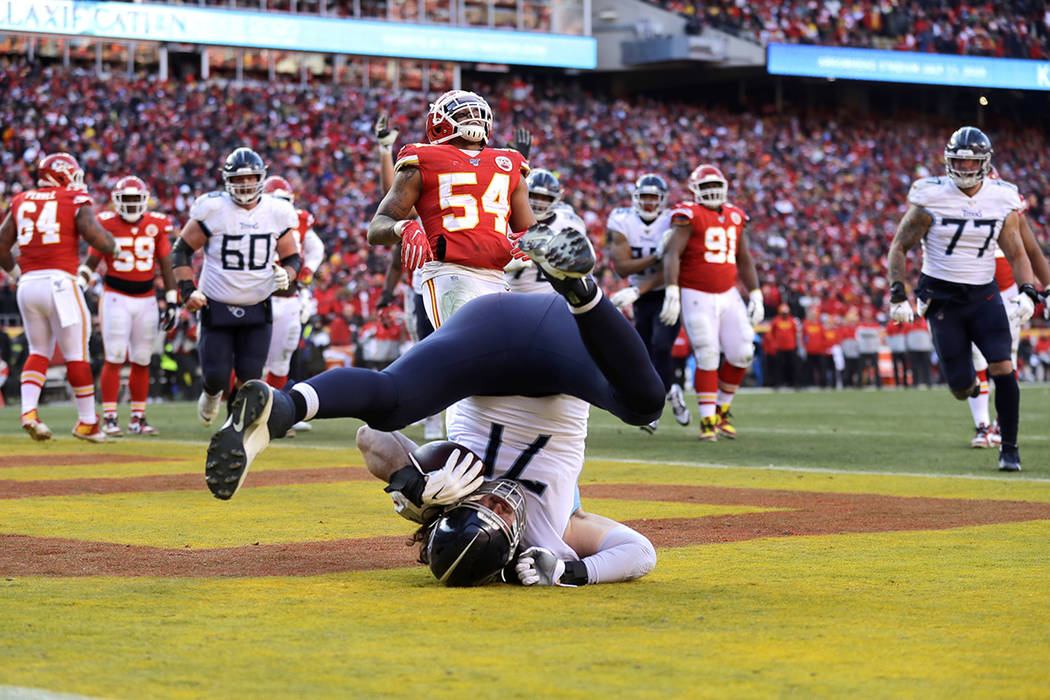 Tennessee Titans' Dennis Kelly (71) catches a touchdown pass during the first half of the NFL A ...