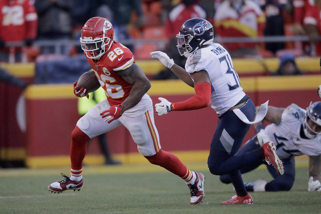Kansas City Chiefs' Damien Williams runs away from Tennessee Titans safety Kevin Byard (31) dur ...