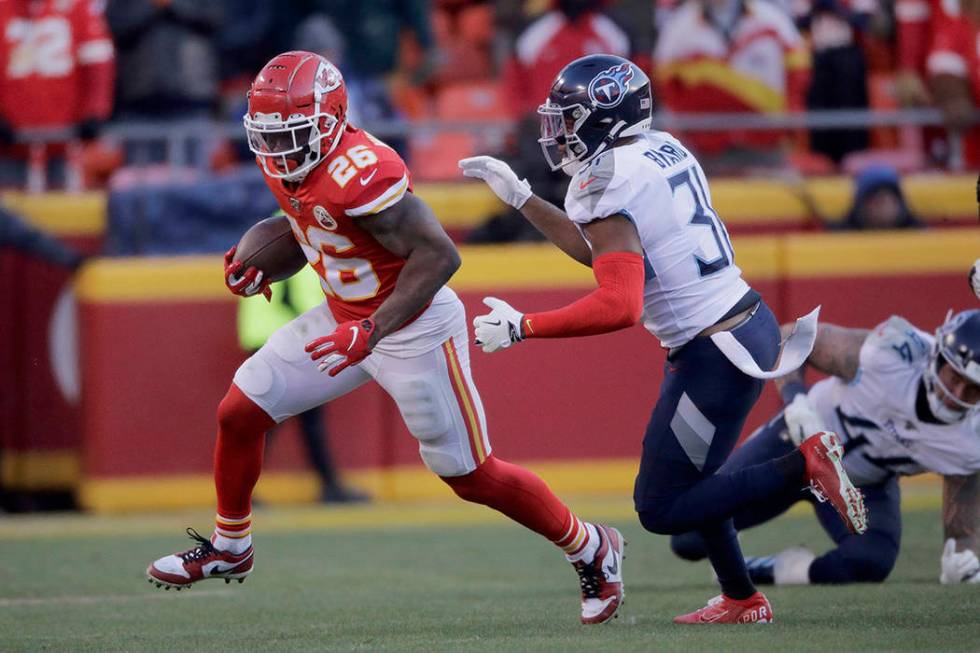 Kansas City Chiefs' Damien Williams runs away from Tennessee Titans safety Kevin Byard (31) dur ...