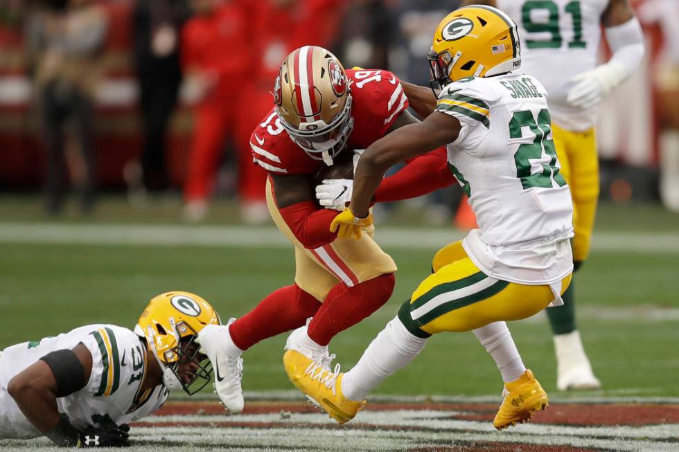 San Francisco 49ers wide receiver Deebo Samuel (19) runs between Green Bay Packers free safety ...