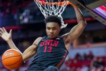 UNLV Rebels guard Bryce Hamilton (13,) drives on dunks the ball over New Mexico Lobos forward C ...