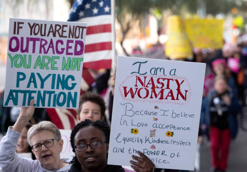 The Empowering Women March 2020 walks through downtown Las Vegas on Saturday, Jan. 18, 2020. (E ...