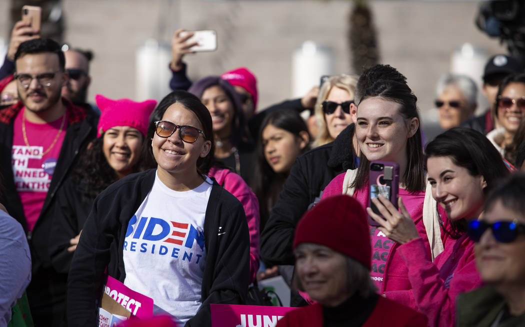 Members of the crowd smile at speakers during the Empowering Women March 2020 on Saturday, Jan. ...