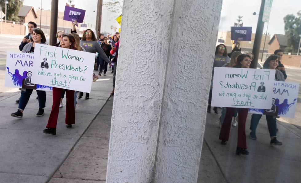 Destiny Reinoehl holds a sign supporting presidential candidate Elizabeth Warren as she marches ...