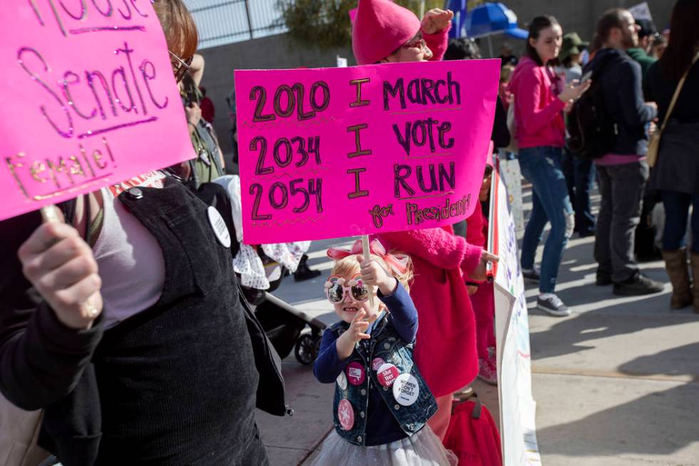 Molly Lynch attends the Empowering Women March 2020 with her daughter McKenzie Fink,4, center, ...