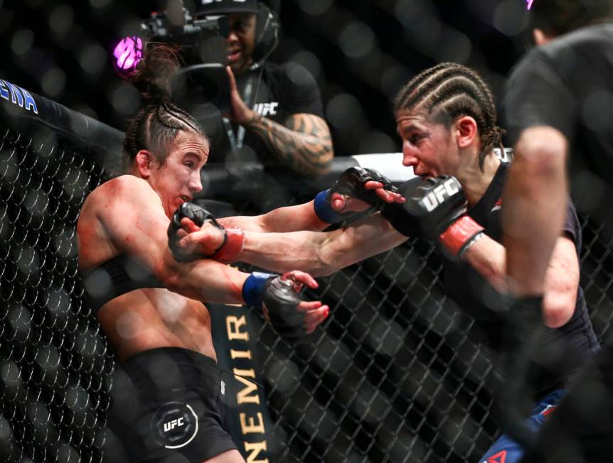 Maycee Barber, left, gets knocked to the cage by Roxanne Modafferi during their flyweight bout ...