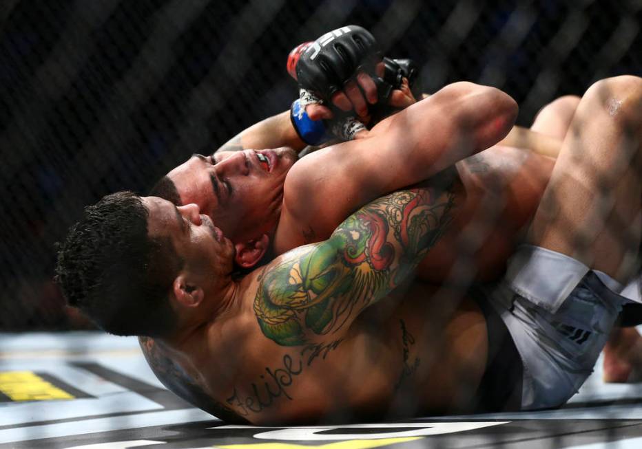 Diego Ferreira, left, fights Anthony Pettis during their lightweight bout at UFC 246 at T-Mobil ...