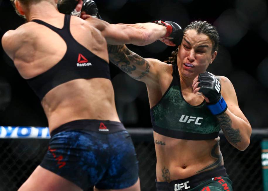 Holly Holm, left, fights Raquel Pennington during their bantamweight bout at UFC 246 at T-Mobil ...