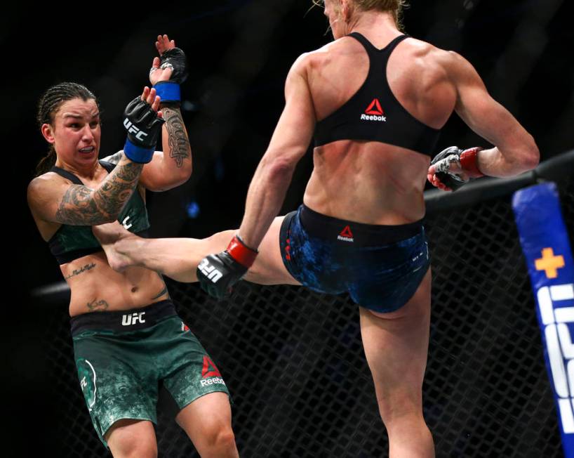 Raquel Pennington, left, fights Holly Holm during their bantamweight bout at UFC 246 at T-Mobil ...