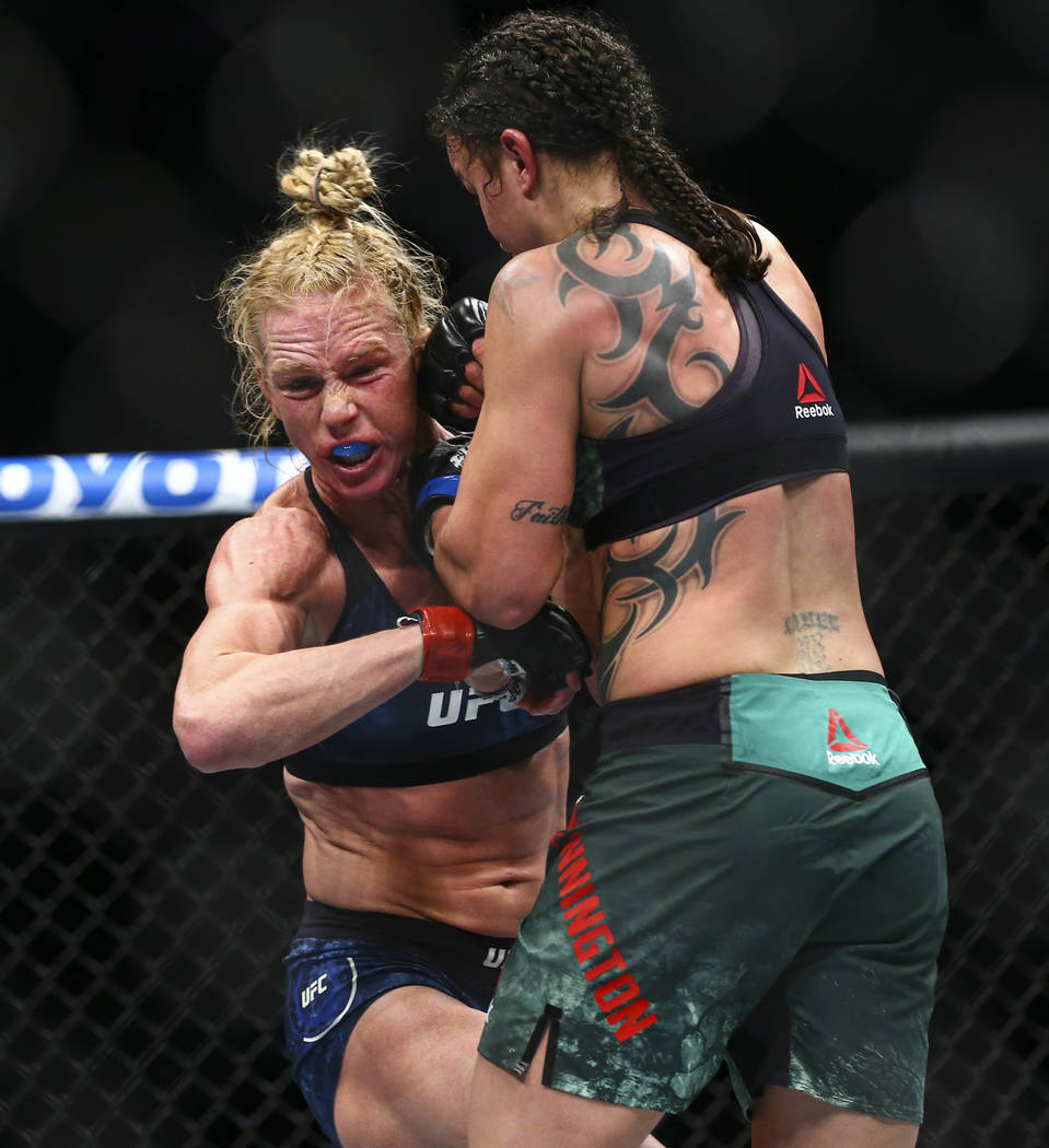 Holly Holm, left, fights Raquel Pennington during their bantamweight bout at UFC 246 at T-Mobil ...