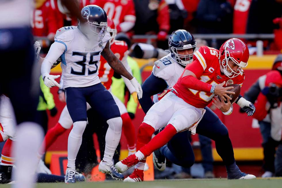 Kansas City Chiefs' Patrick Mahomes runs for a touchdown past Tennessee Titans defensive tackle ...