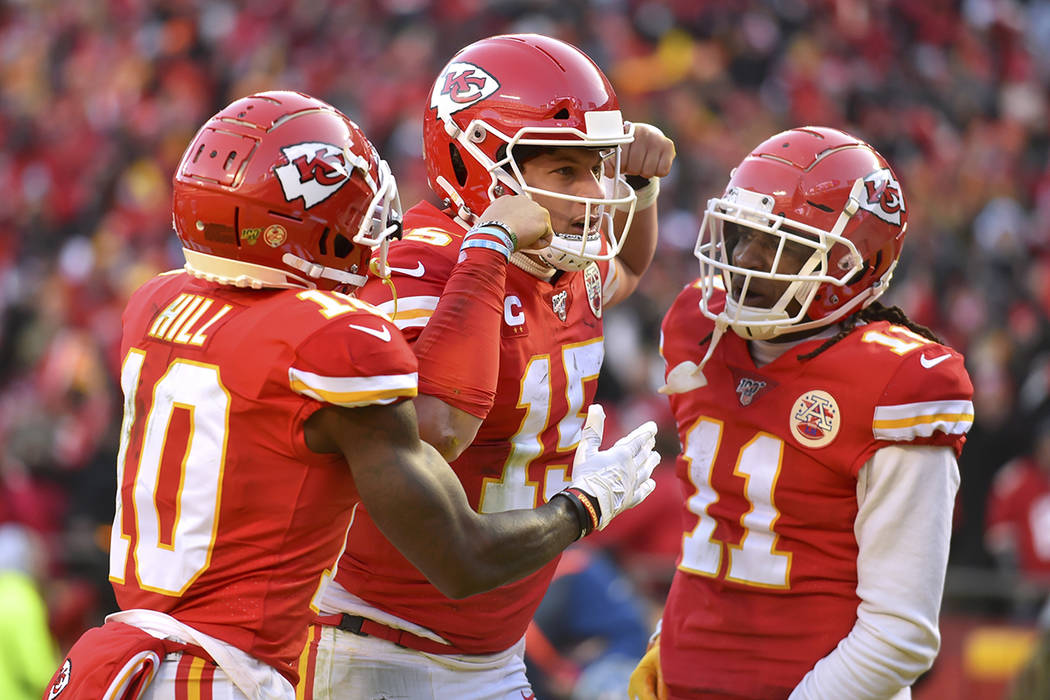 Kansas City Chiefs' Patrick Mahomes (15) celebrates with Tyreek Hill (10) and Demarcus Robinson ...