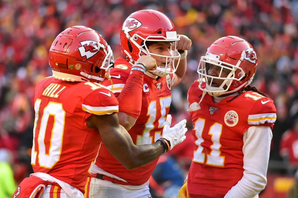 Kansas City Chiefs' Patrick Mahomes (15) celebrates with Tyreek Hill (10) and Demarcus Robinson ...