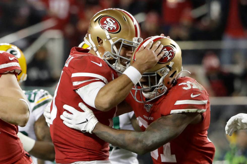 San Francisco 49ers running back Raheem Mostert, right, celebrates his touchdown with quarterba ...