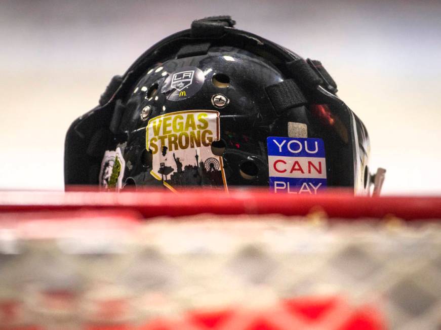 Flamingos goalie sports stickers on the back of his helmet versus the Blackjacks in their semi- ...