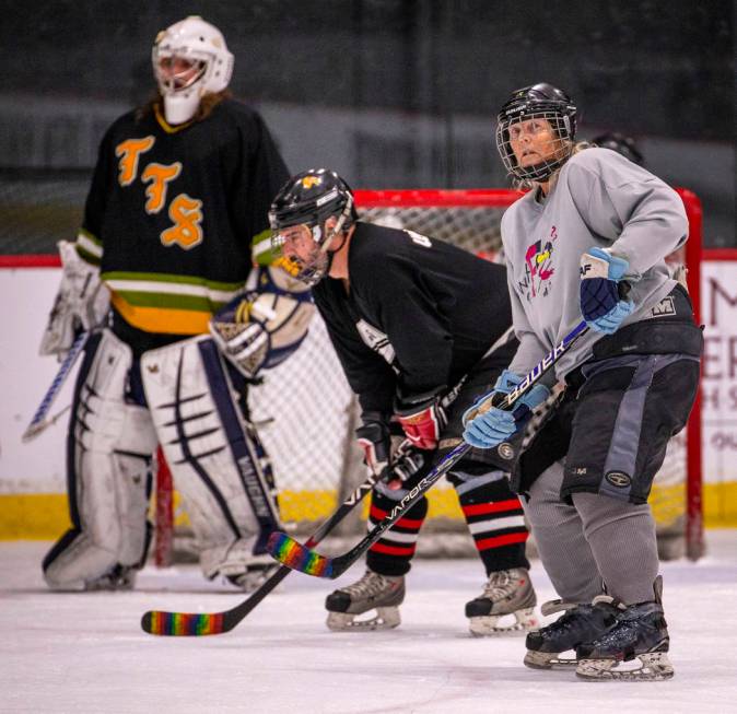 Brynne Van Putten, right, with the Flamingos looks up the ice with other players during the Sin ...