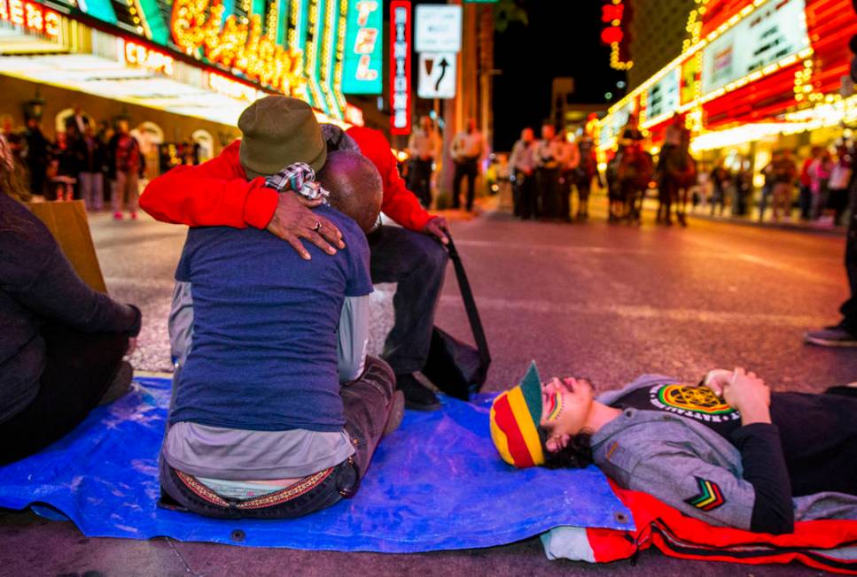 The Rev. Harold Washington-Carnes hugs another local activist as she helps blocks Casino Center ...